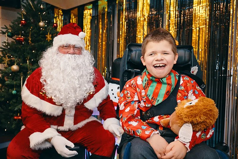 Children posing happily with Santa during Forward Facing Christmas celebration