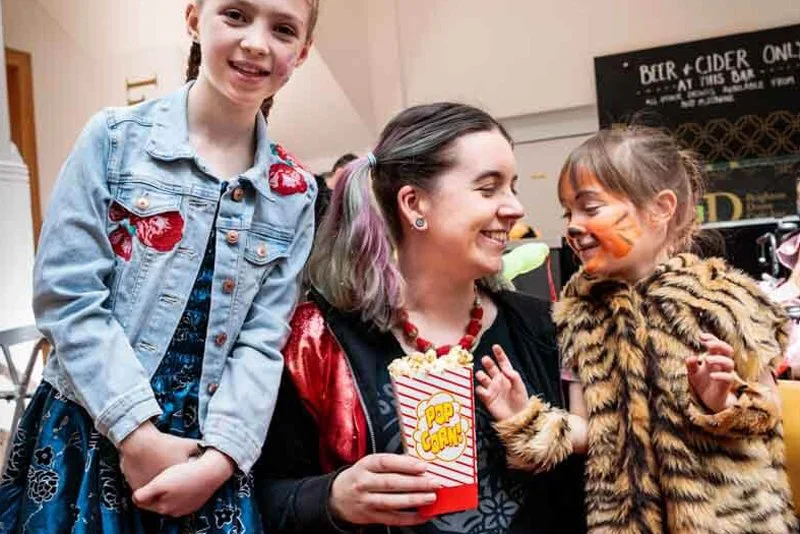 A child dressed in a tiger suit enjoying snacks at Memory Making Day