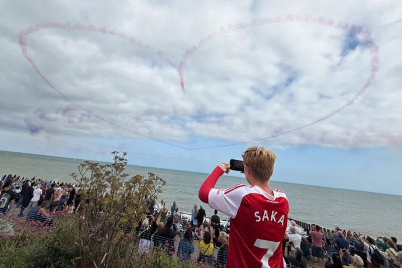 Crowds watch an aerobatic display at the seafront during the Forward Facing Airbourne event