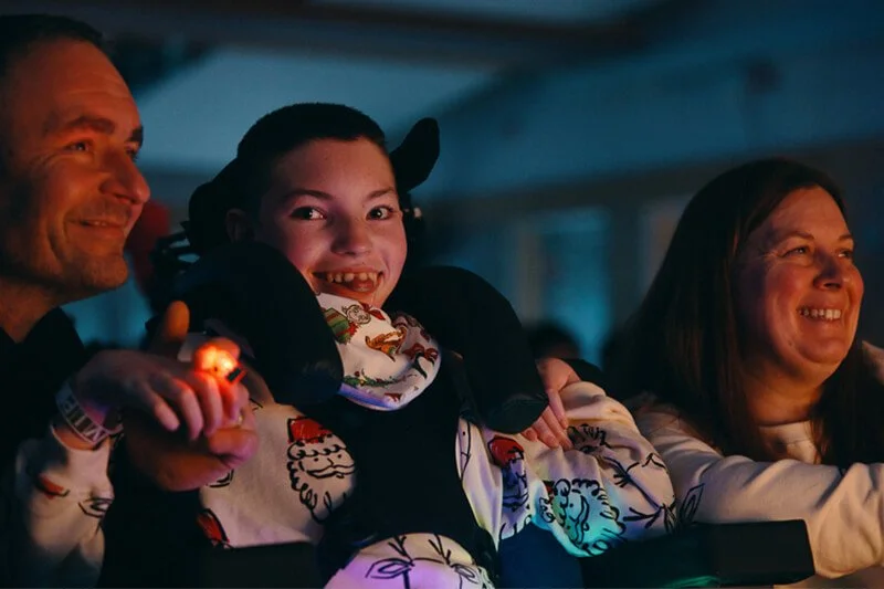 Children gathered around Santa Claus with gift bags at the Christmas celebration