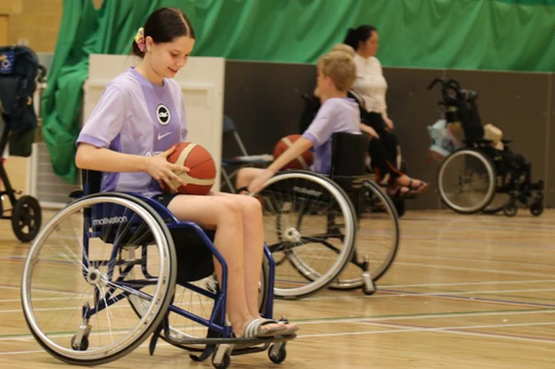 Children playing adaptive basketball together at a Forward Facing activity day