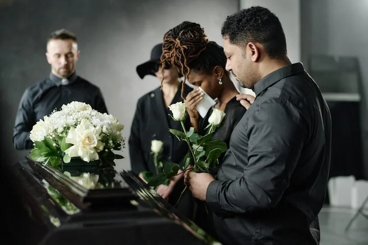 A warm cup of tea, candle and open notebook by a window