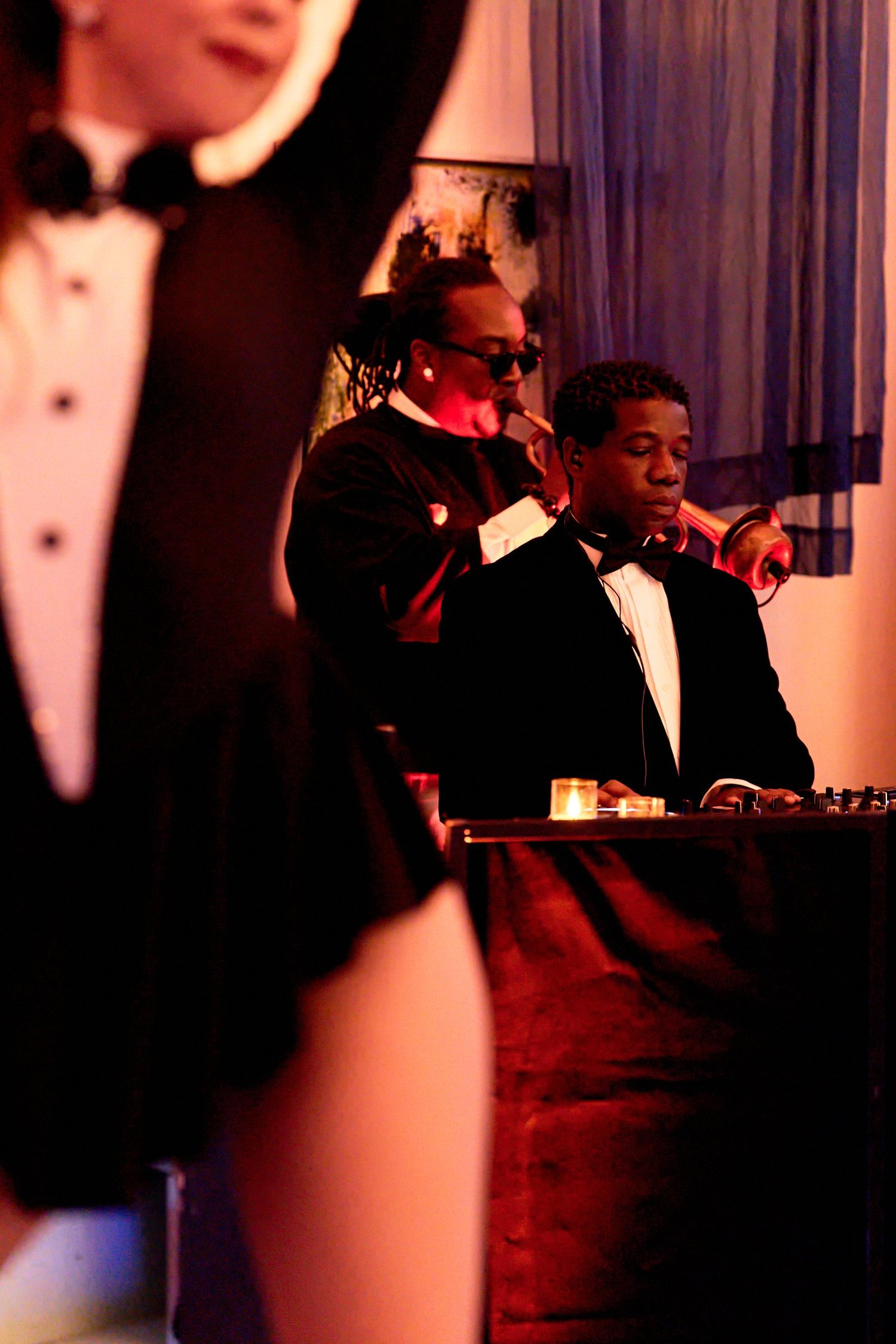 Dancer with saxophone performer and sound engineer in the background at Classified