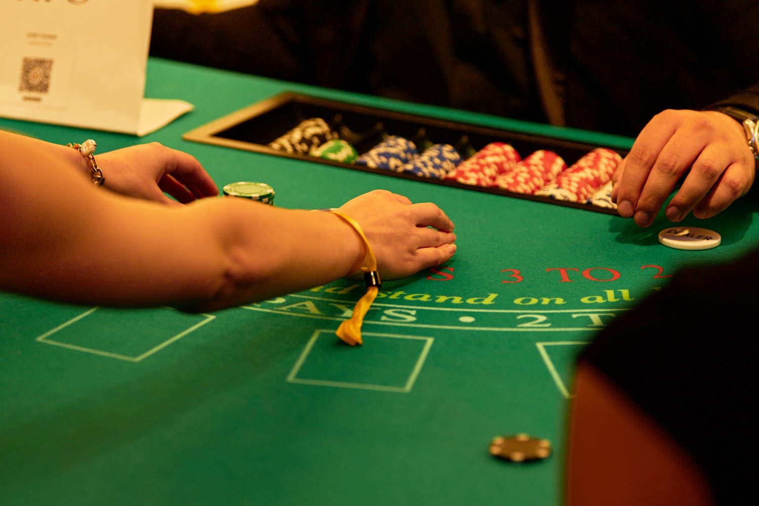 Female hands on casino table game at Classified