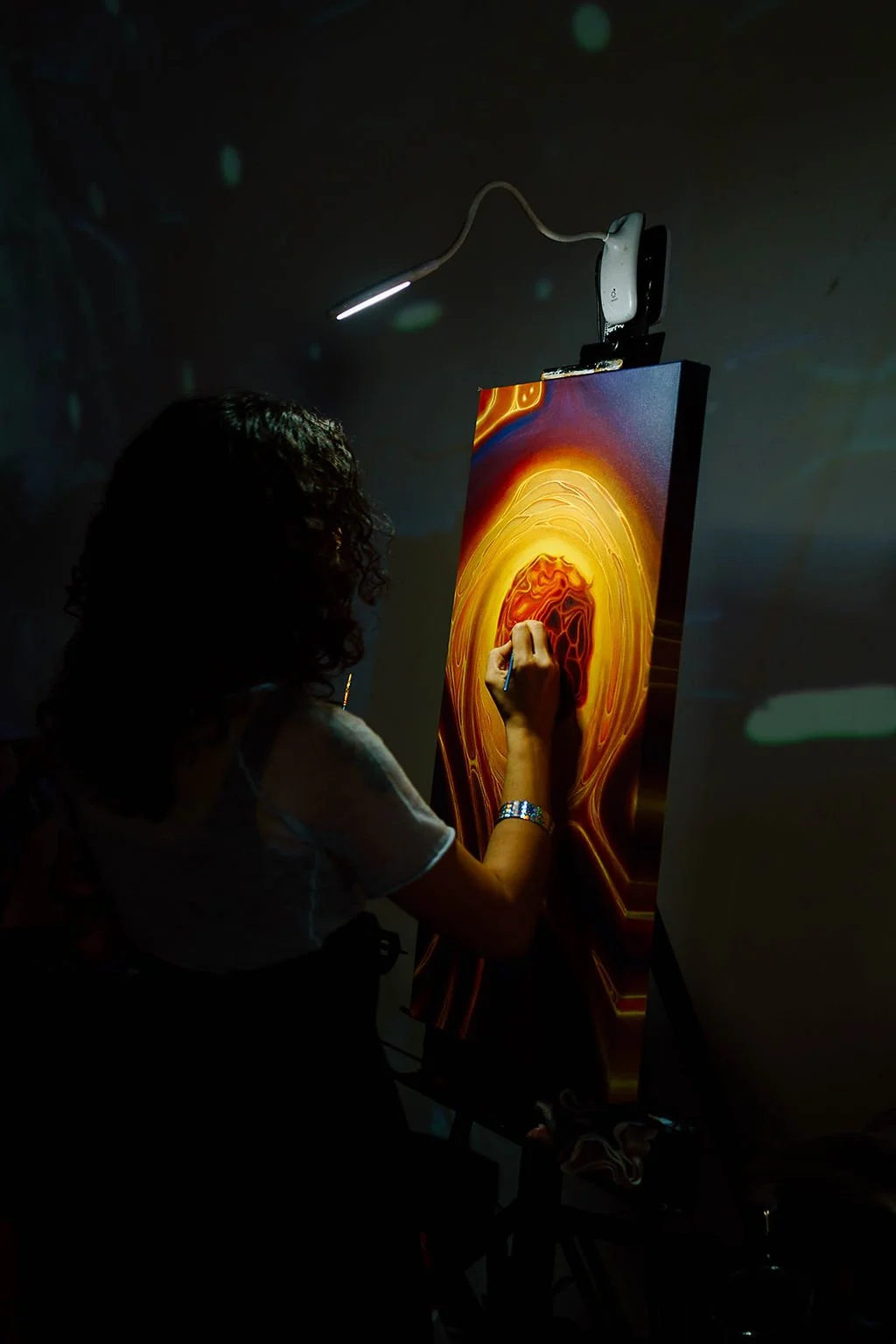 Female artist painting live at Celestial