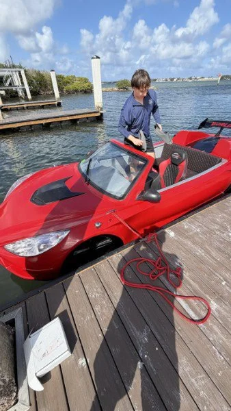 Red Corvette jet car on the water