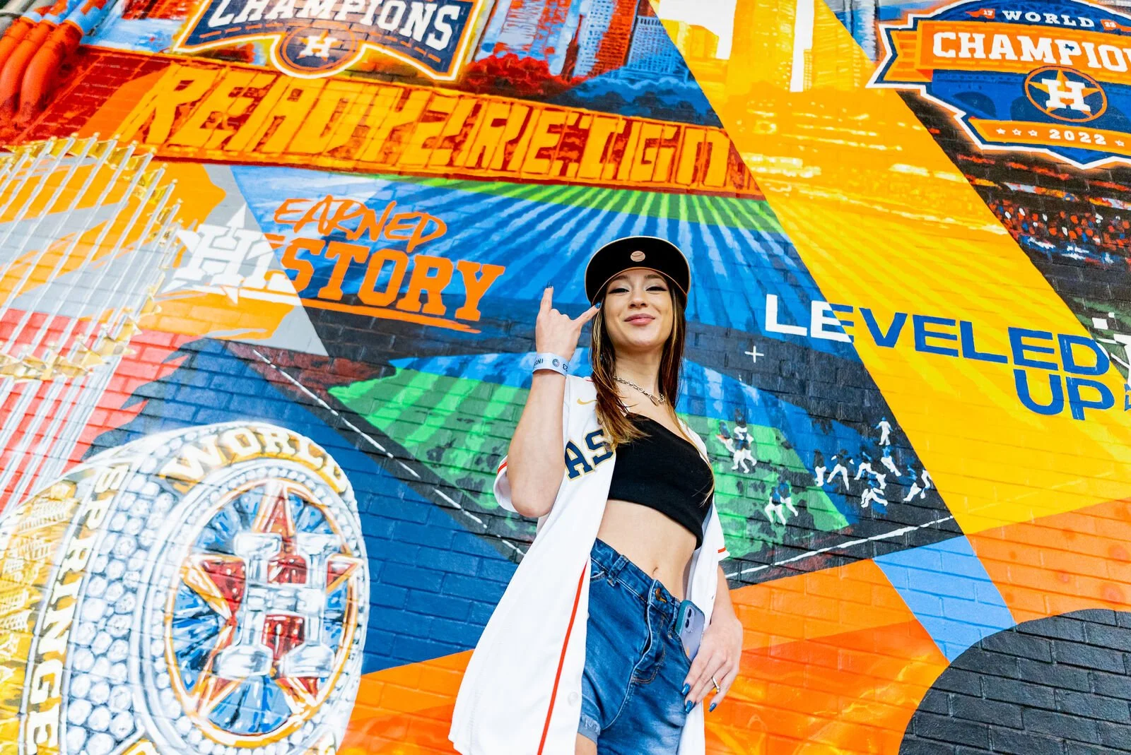 Fan posing in front of the Astros championship mural
