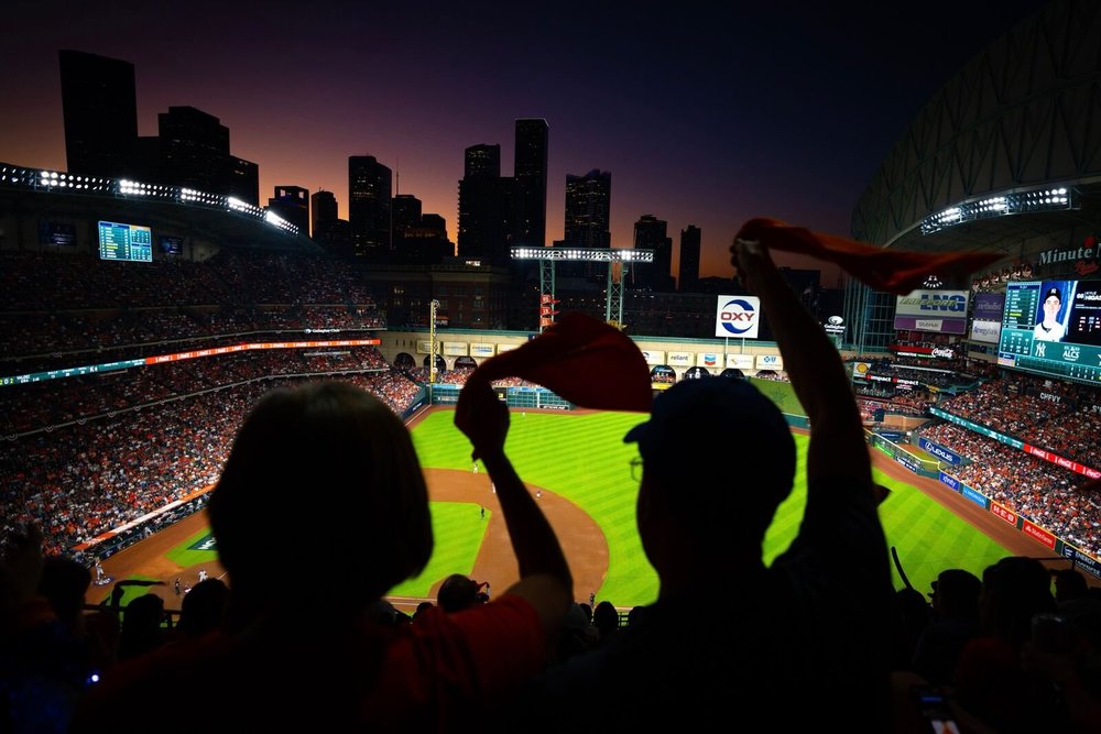 Fans silhouetted against the Houston skyline