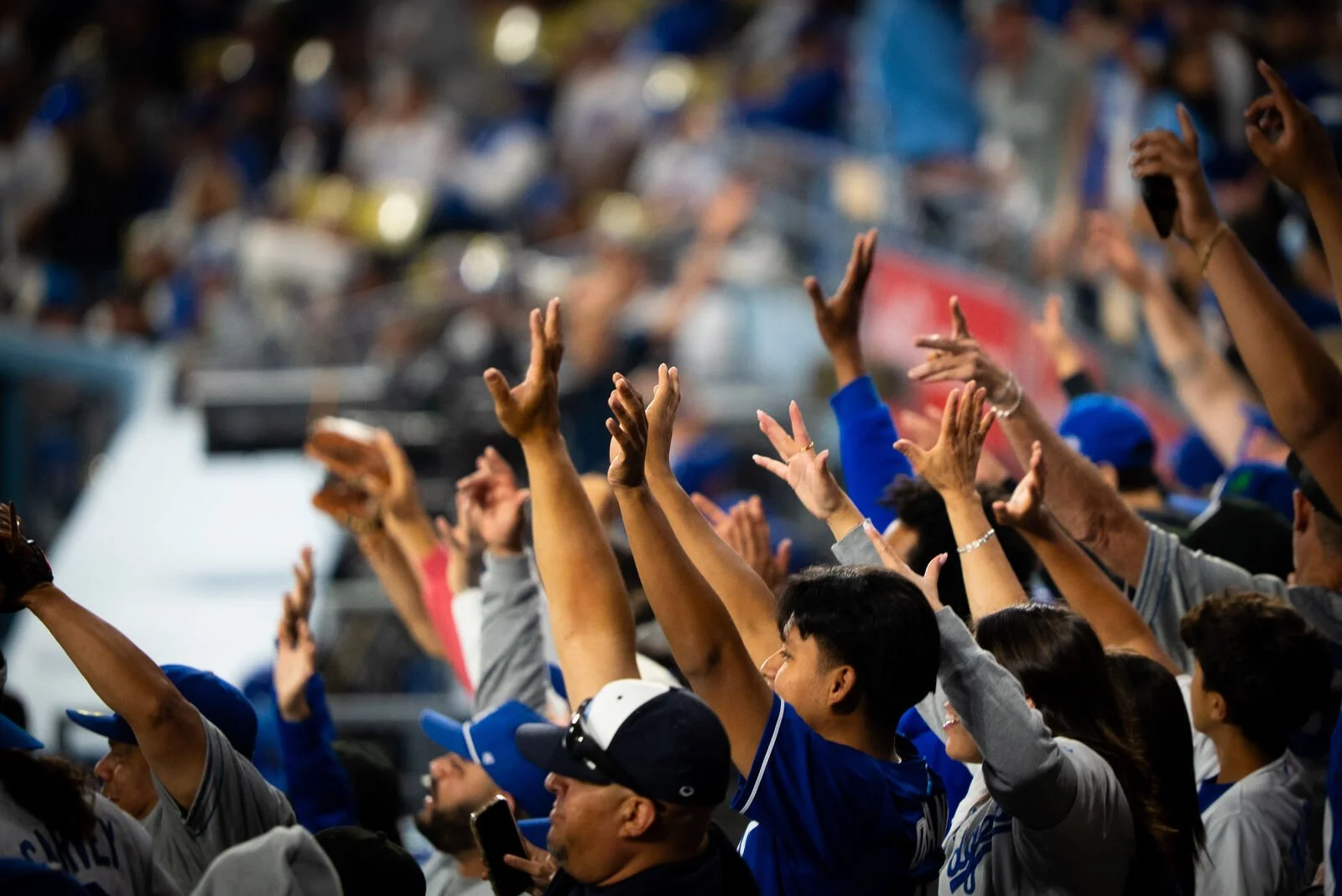 Fans reaching for a ball in the stands