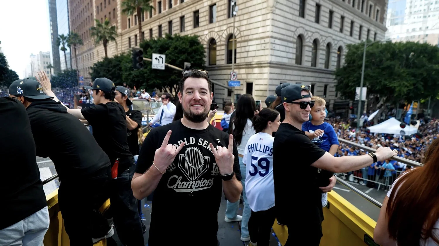 Matthew celebrating on a bus at the Dodgers World Series championship parade