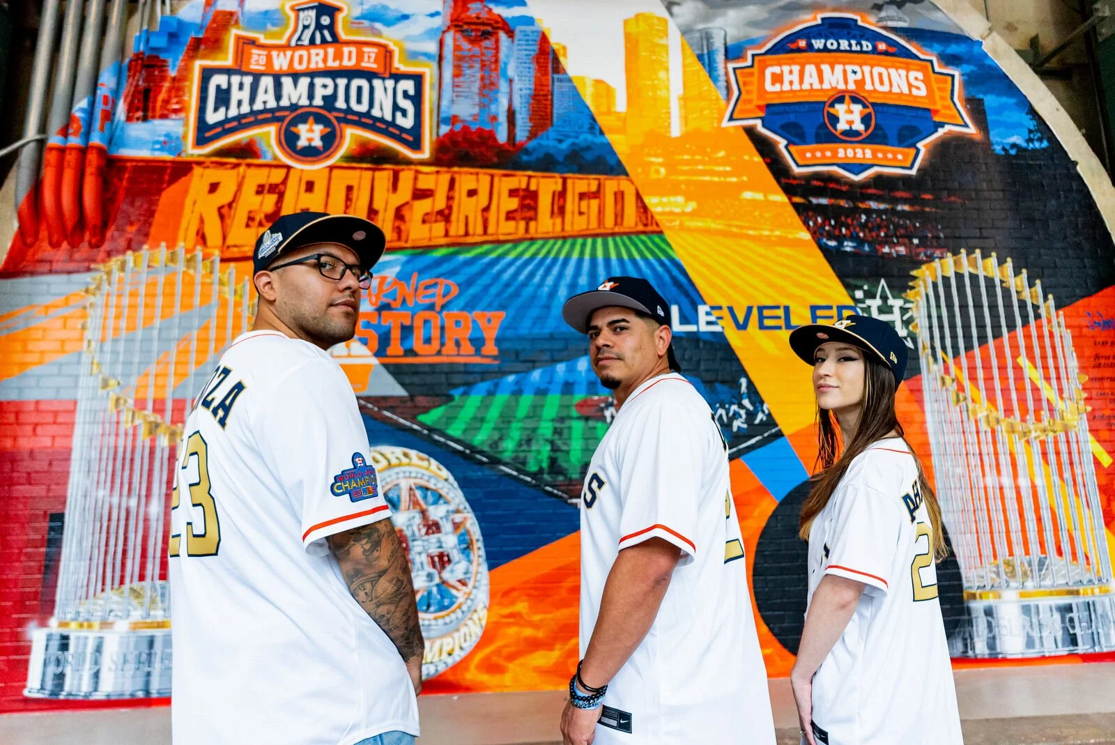 Astros players in front of a championship mural