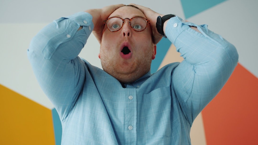 Homeowner placing a For Sale By Owner sign in front yard attempting to sell independently.