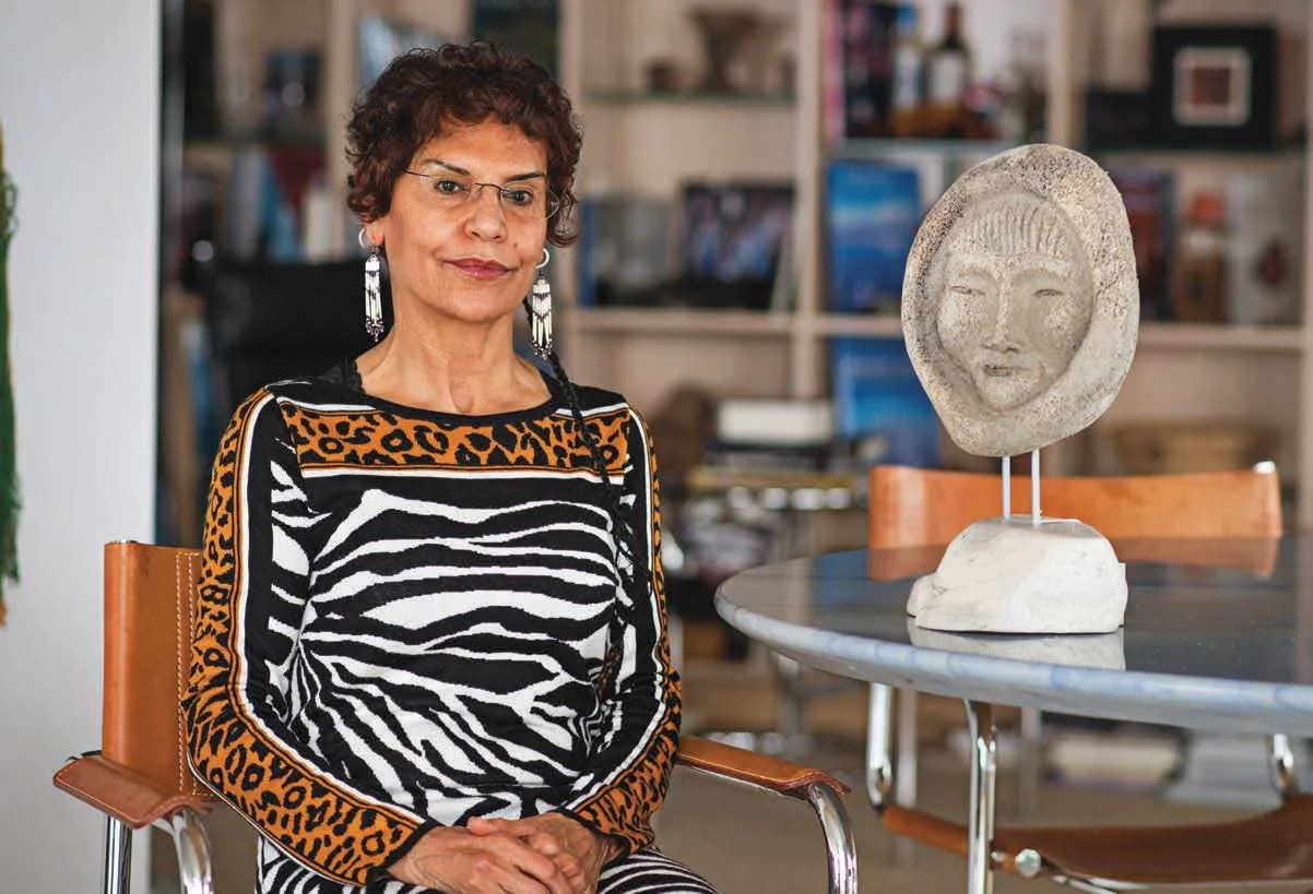 Sima Sharifi at her Vancouver home with a carving by Billy Merkosak, Nunavut.