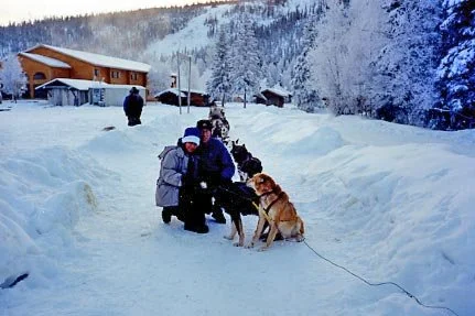 Sima and Arnold dog mushing in Alaska during the early days of their relationship