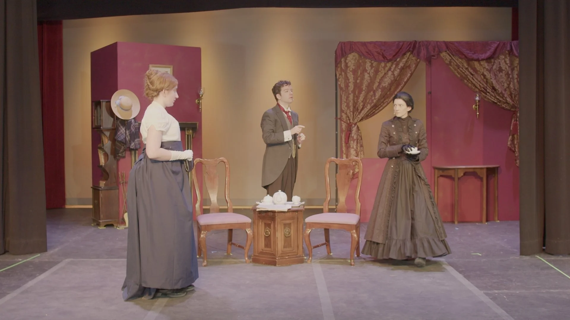 Mary and Mrs. Hawking meeting for the first time at Mrs. Hawking's house. Nathaniel speaks between them.