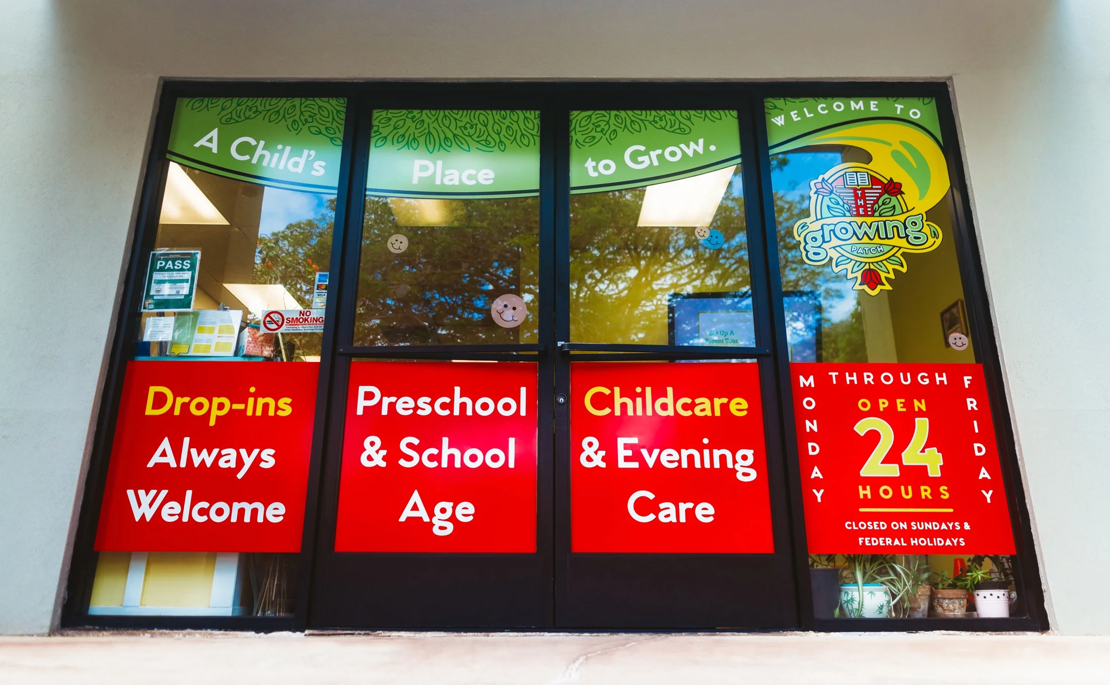 The Growing Patch storefront entrance with window signage for preschool, childcare, and drop-in hours