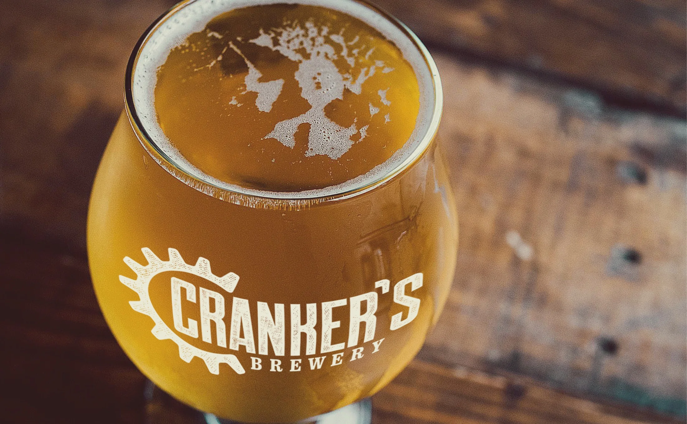Glass of Cranker's Brewery beer with logo etched on the glass