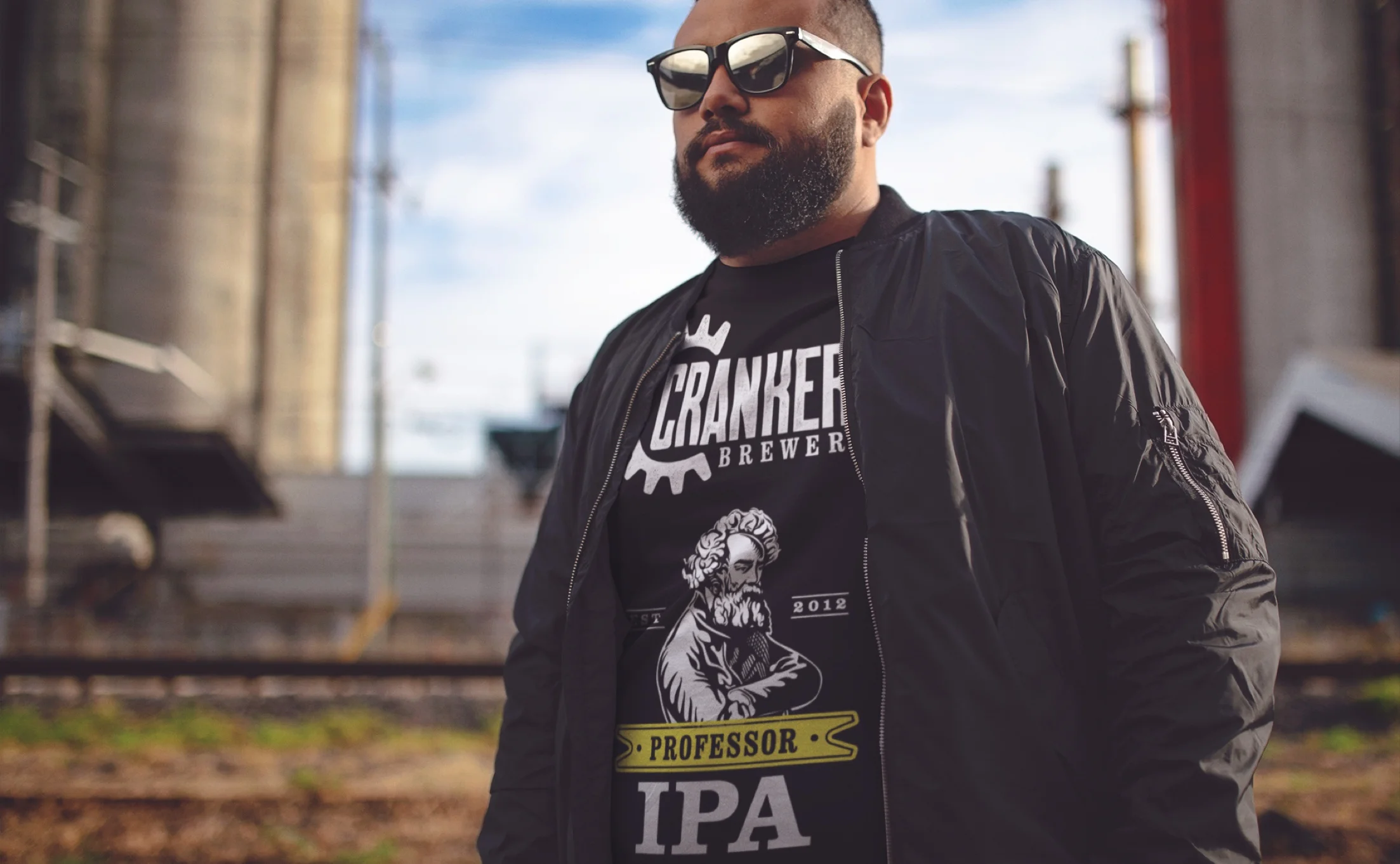 Man wearing a Cranker's Brewery Professor IPA t-shirt under a bomber jacket