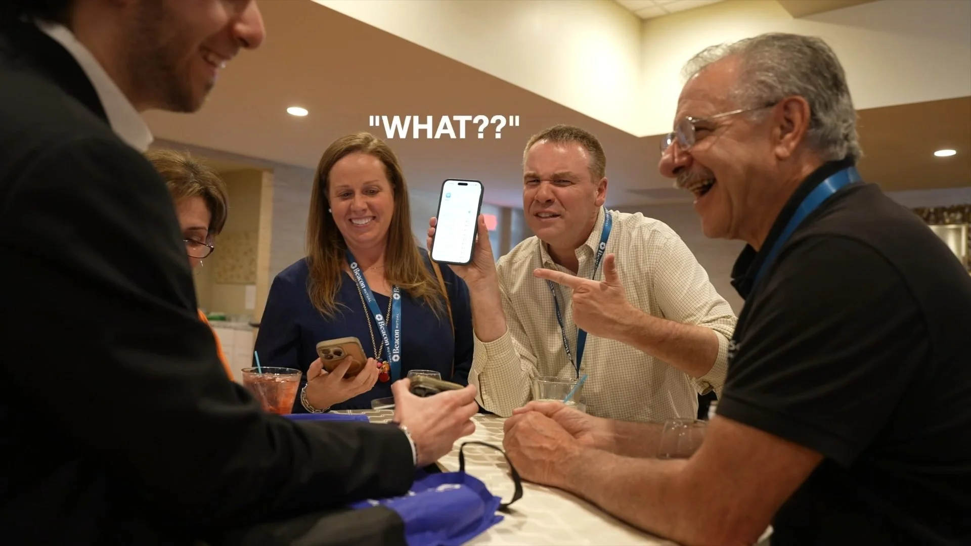Corporate event guests reacting in disbelief to phone magic at a Rhode Island conference