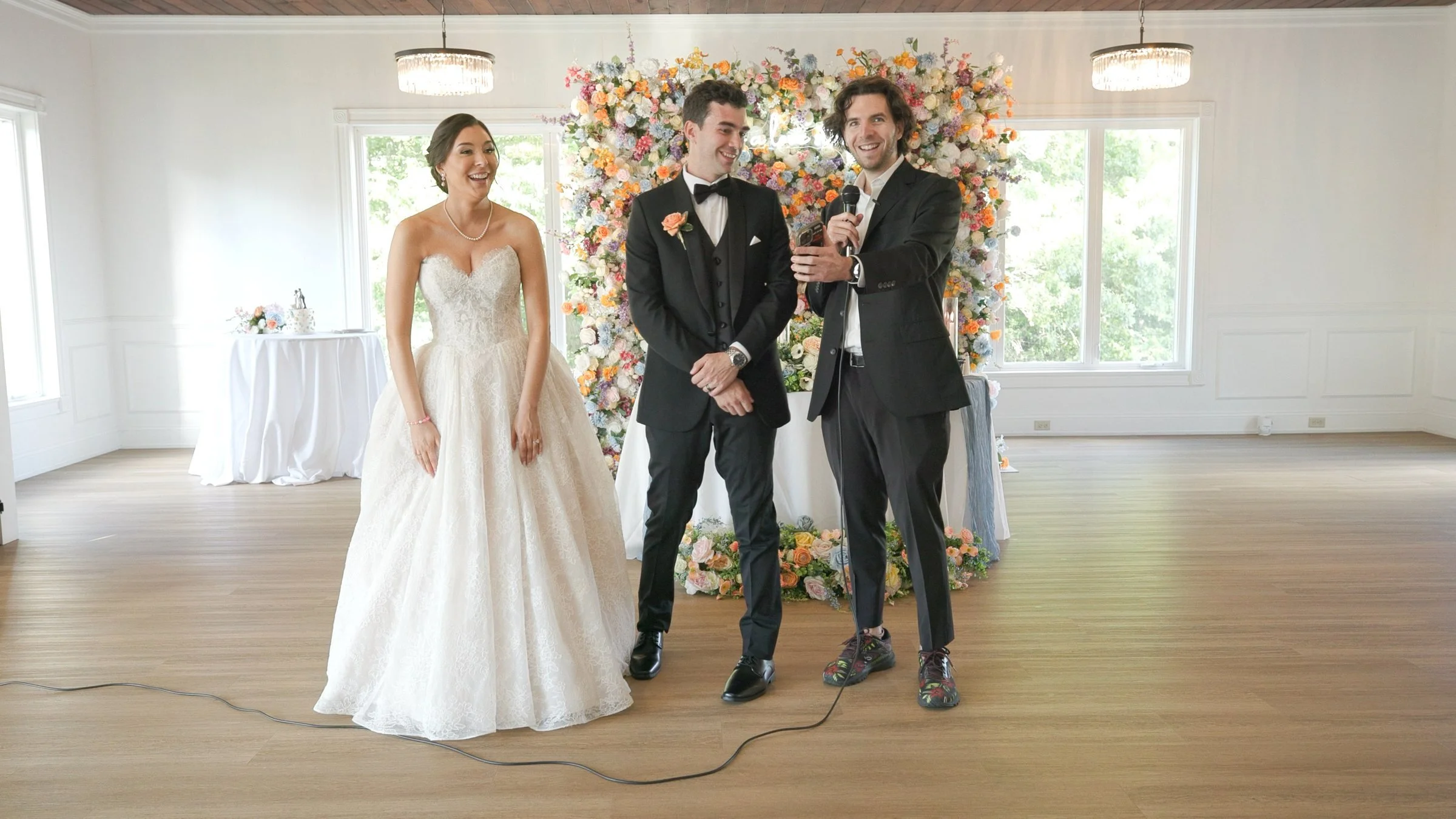 Bride and groom watching a magic performance at their Rhode Island wedding