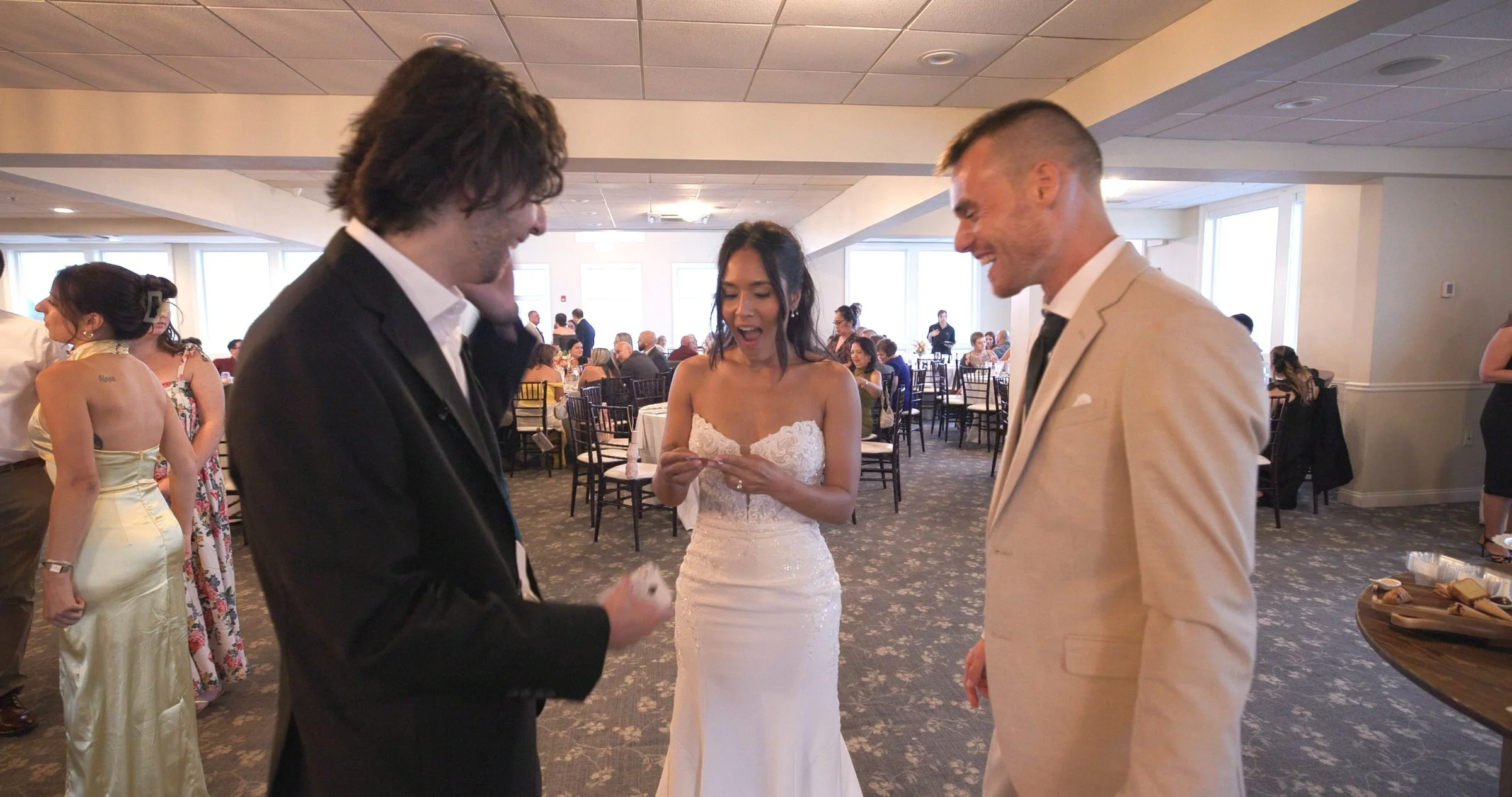 Bride reacting with amazement to close-up magic at her Rhode Island wedding