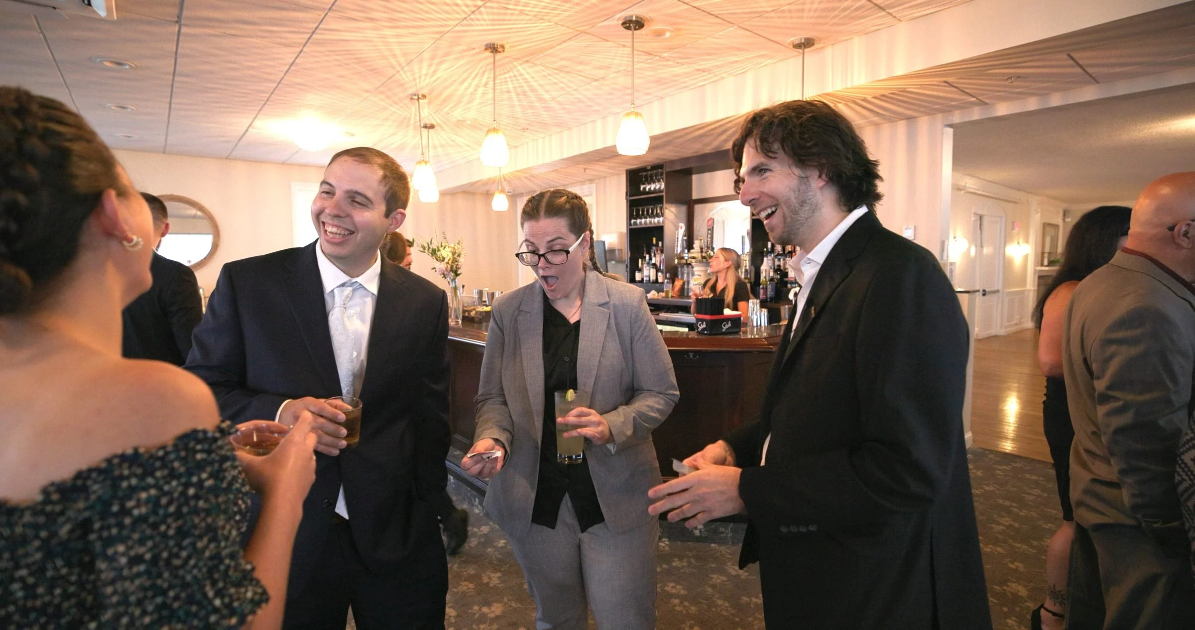 Wedding guests reacting during cocktail hour magic at a Rhode Island wedding