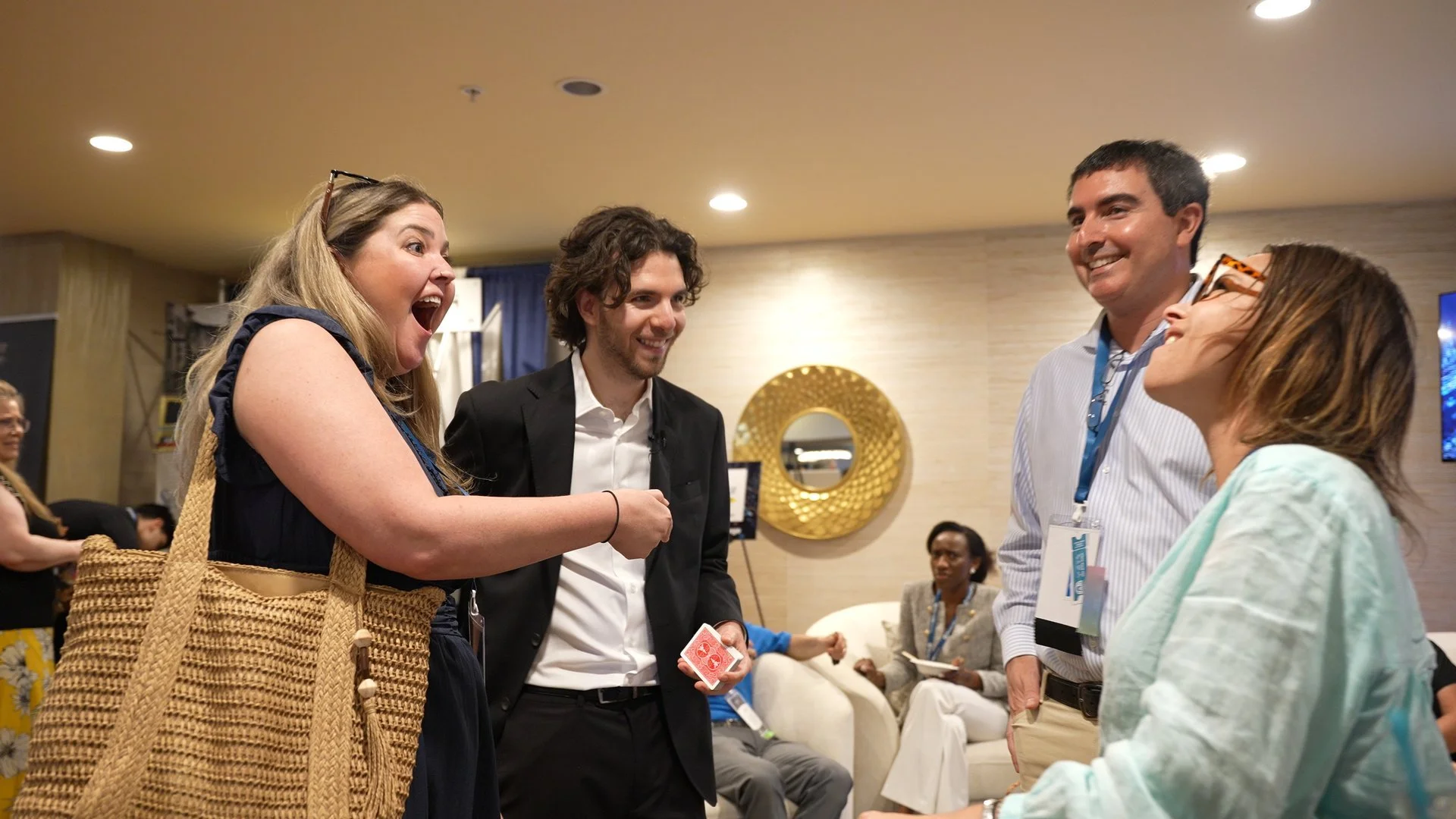 Ben Travelyn performing close-up card magic for guests during a reception
