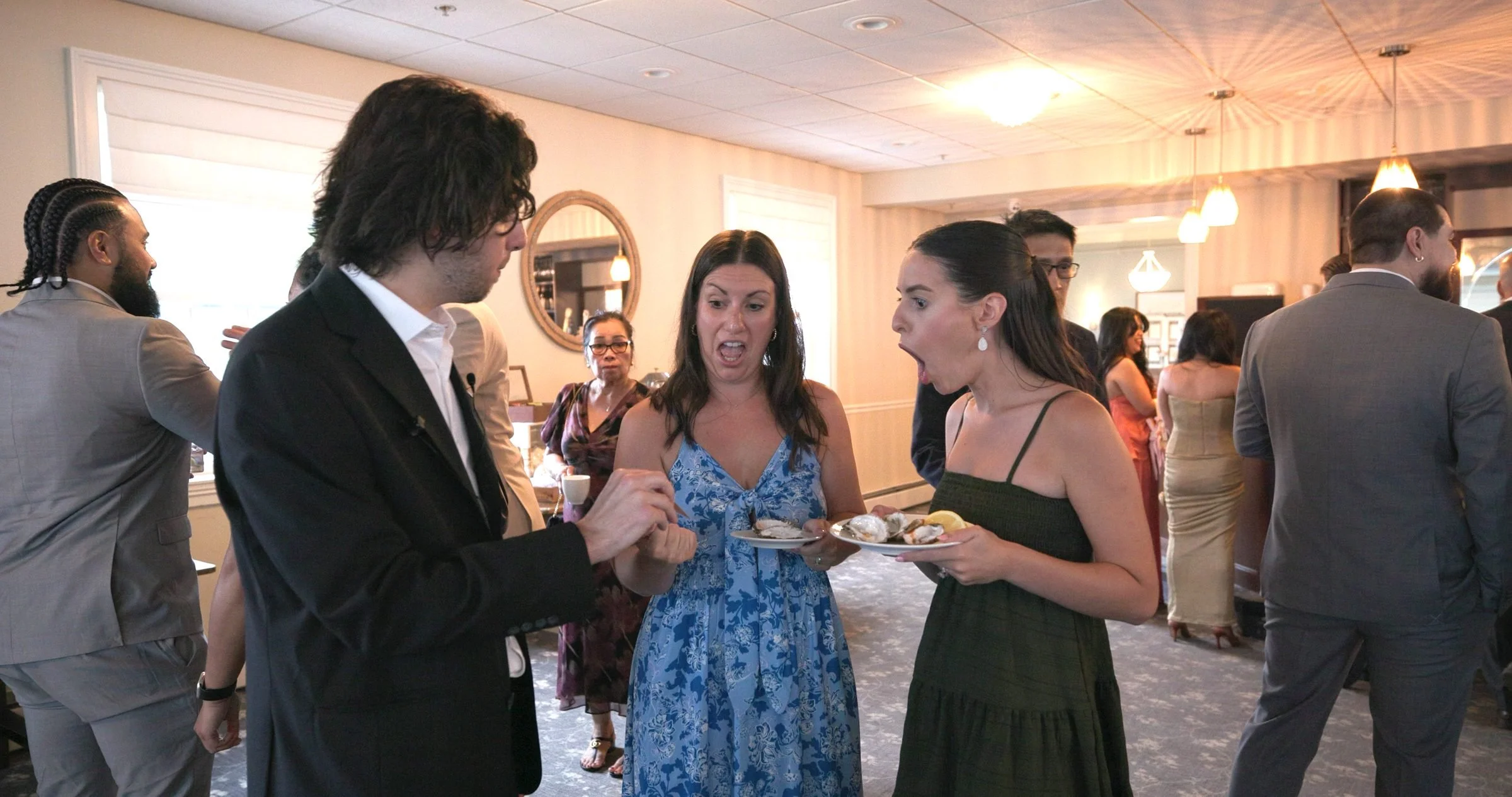 Guests amazed by close-up card magic at a New England event