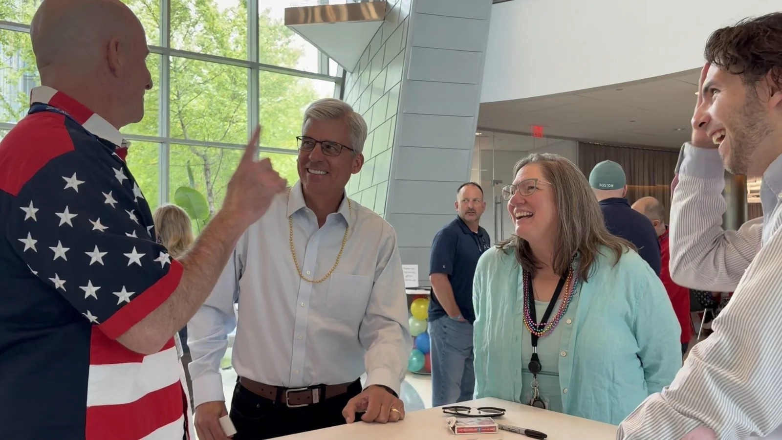 Employee reacting to close-up magic during a company event in Boston