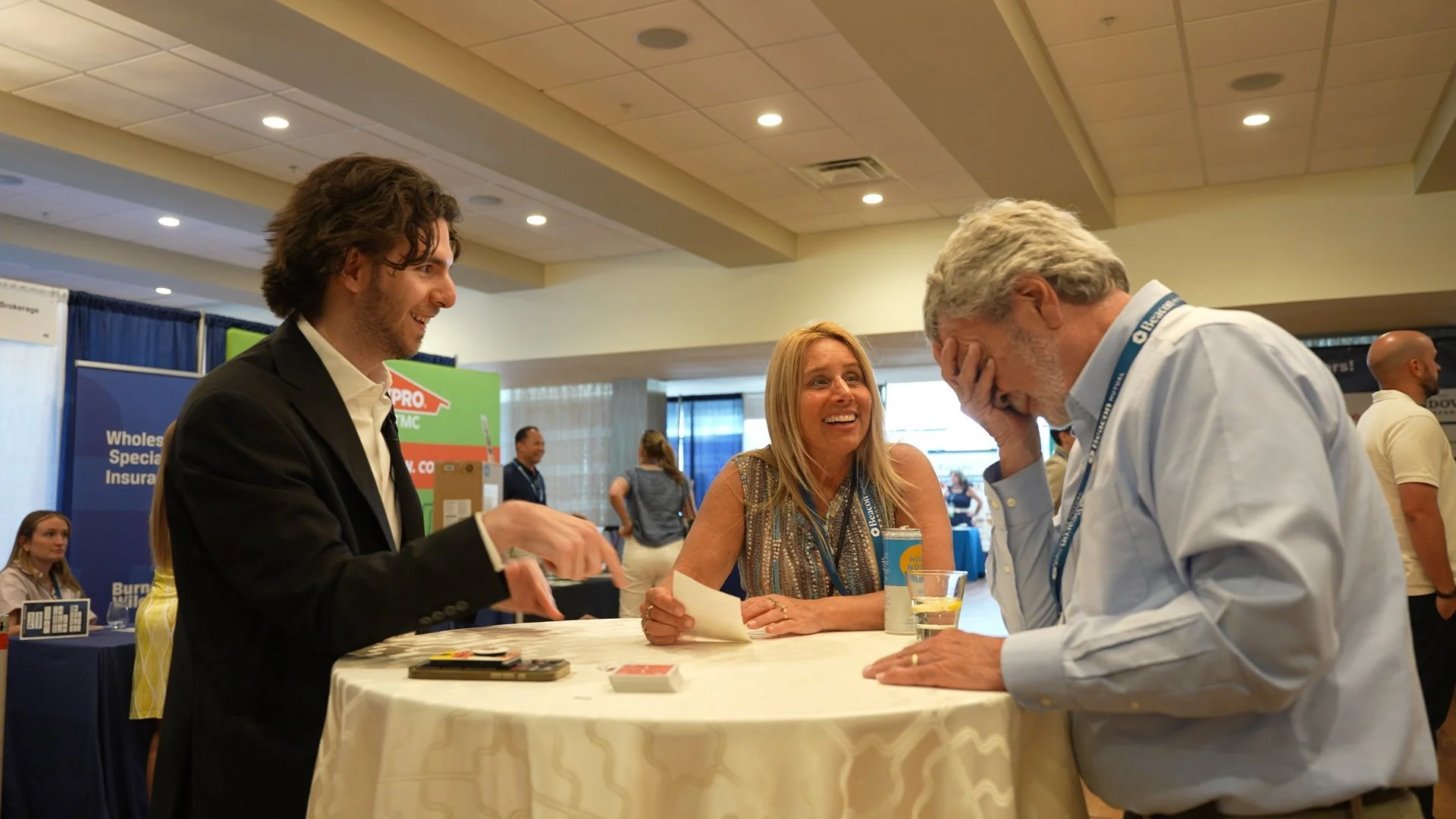 Ben Travelyn performing close-up magic at a corporate networking event in Rhode Island