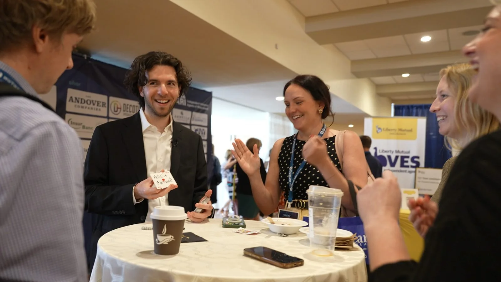 Ben Travelyn performing close-up card magic for a small group at a corporate event