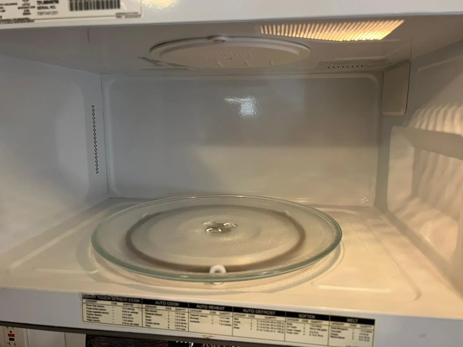 The same microwave interior and glass turntable after cleaning