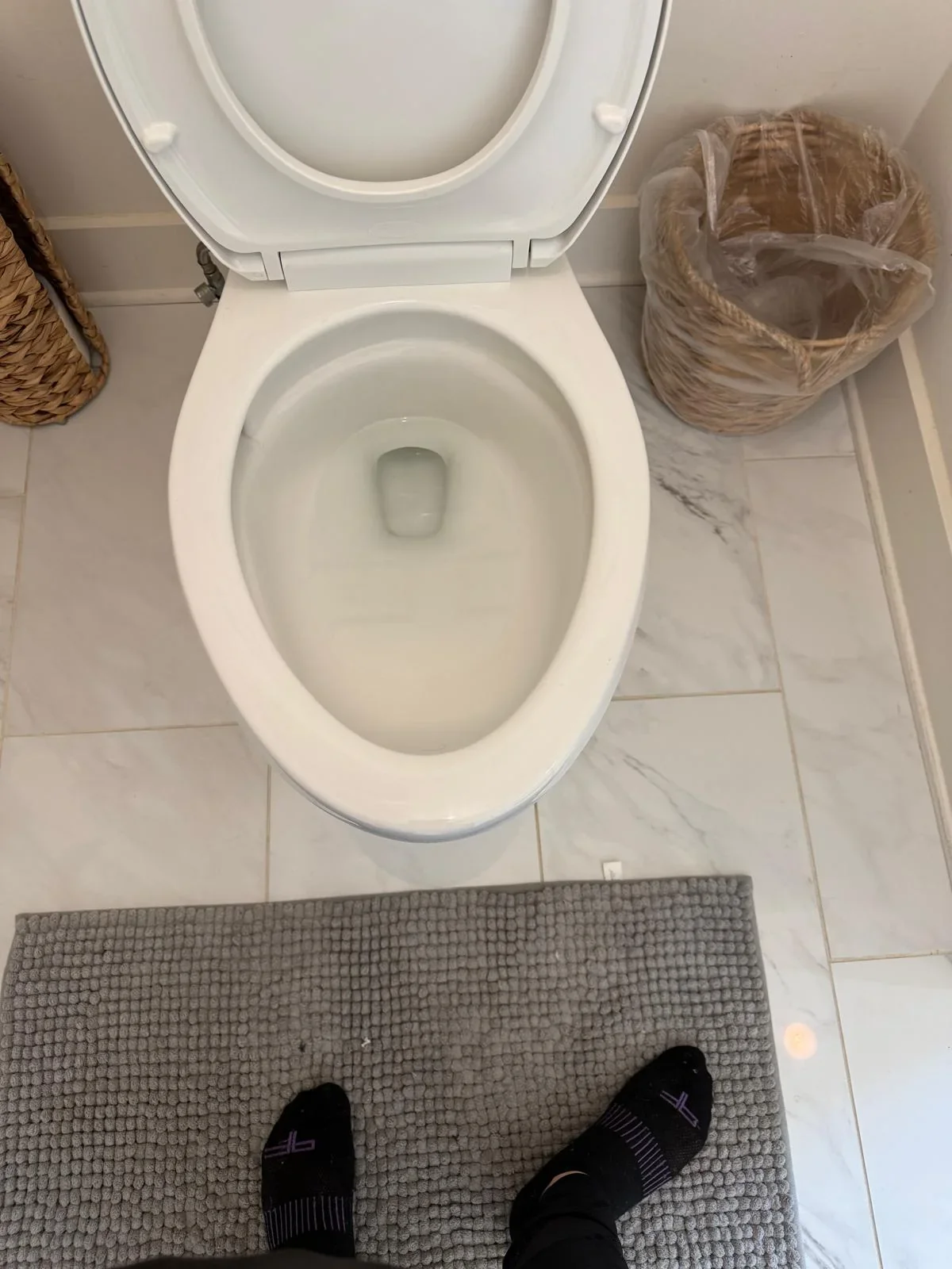 The same white toilet bowl with a visibly cleaner interior after cleaning