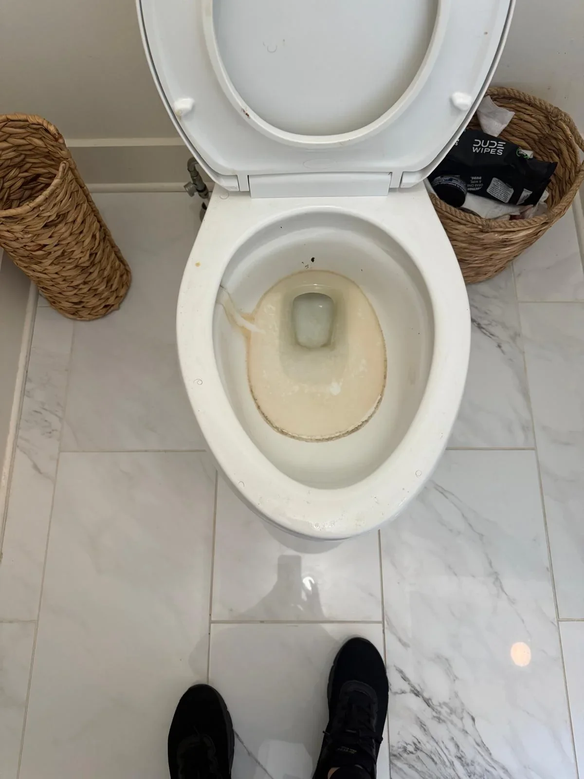 White toilet bowl with visible discoloration and residue before cleaning