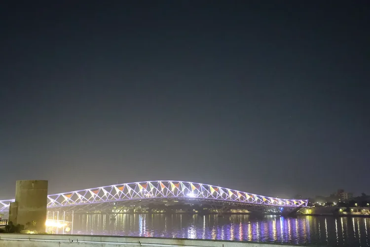 Atal footbridge glowing with lights over the Sabarmati river at night