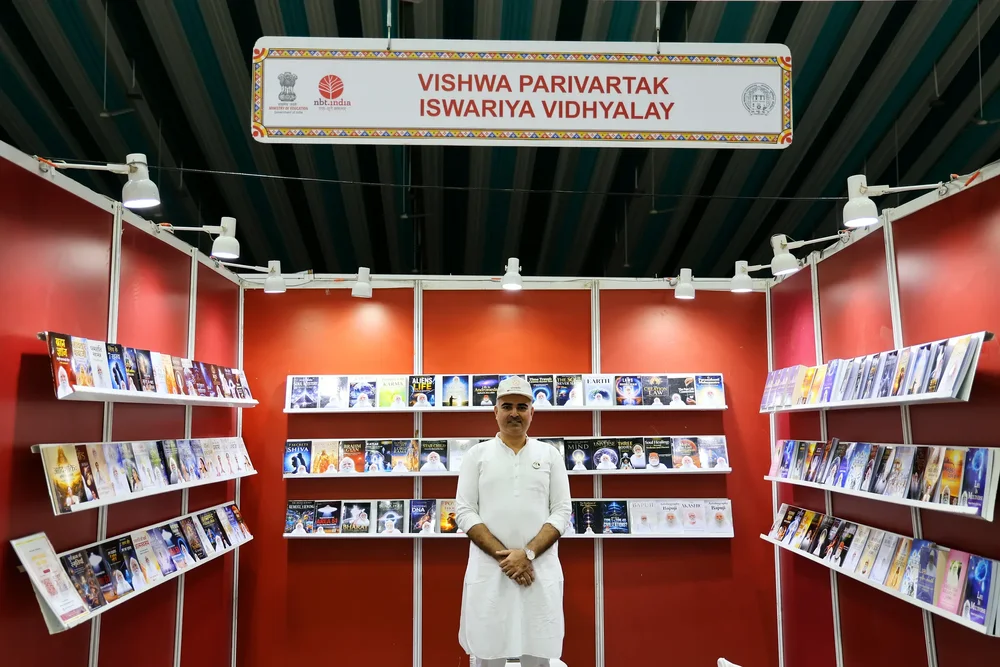 Vishwa Parivartak Iswariya Vidhyalay stall C-47 at Ahmedabad International Book Festival 2026, shelves full of spiritual books