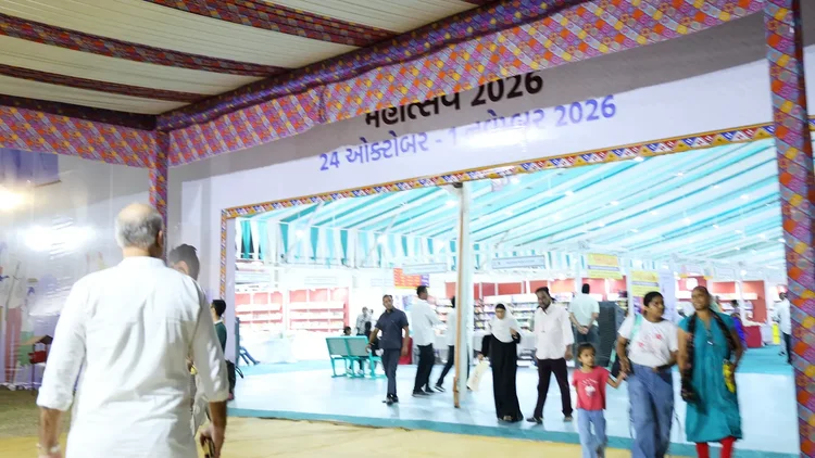 Visitors walking through the decorated festival entrance gate