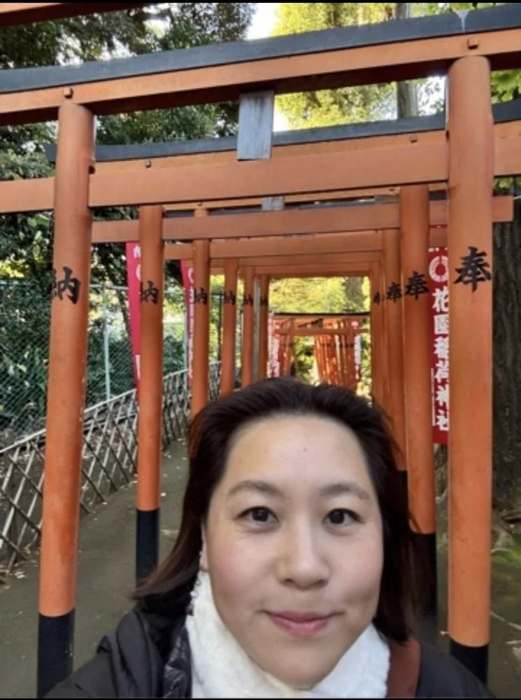 Mika Roland, spiritual director, at a shrine path of red torii gates in Japan