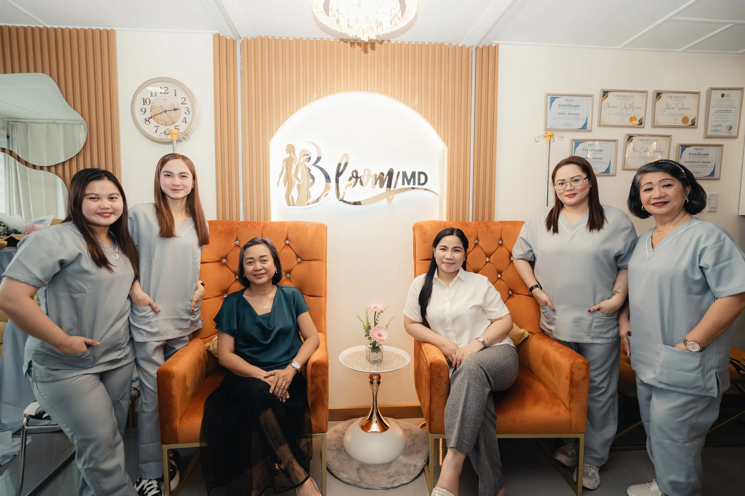 BloomMD medical team — professional portrait in clinic uniforms, serious pose