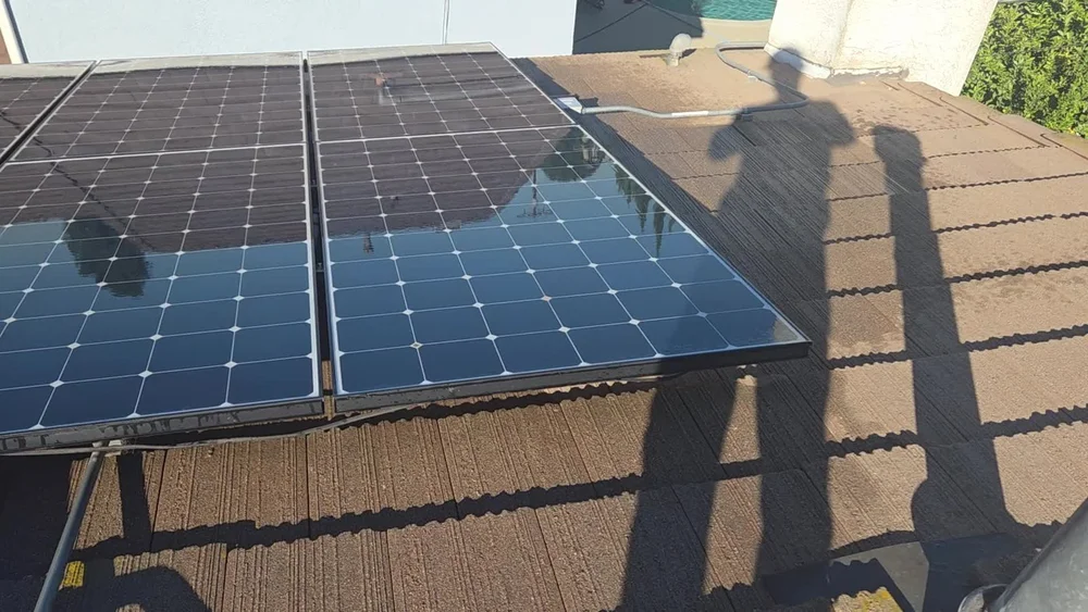 Cleaned tile-roof solar panels shown in a frame from project video