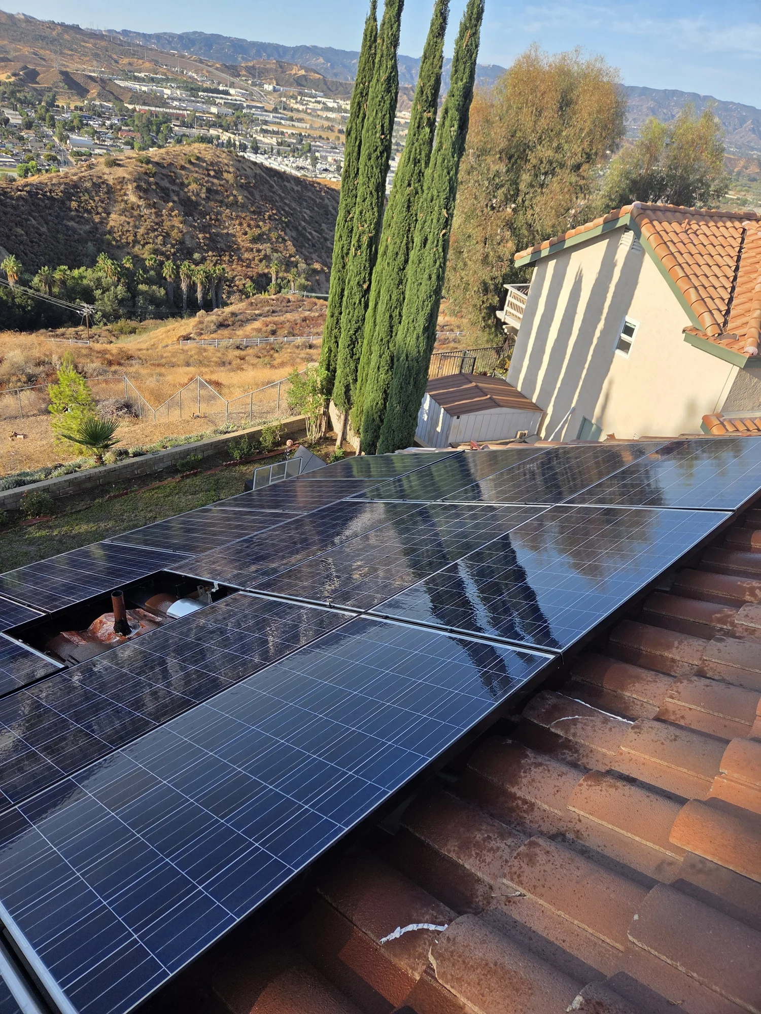 Residential solar panels overlooking nearby hills