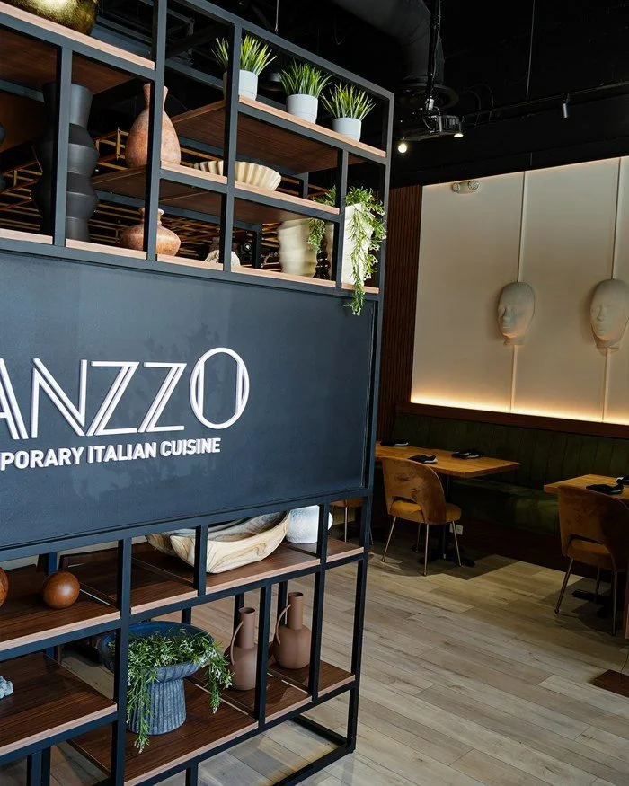 The Manzzo dining room, with banquette seating and the restaurant's signage