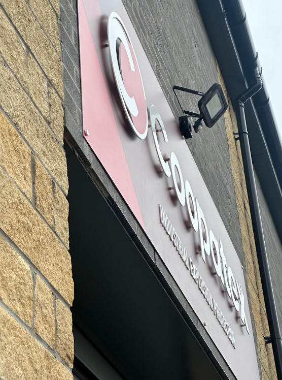 View from below showing the raised letters on the Coopatex sign