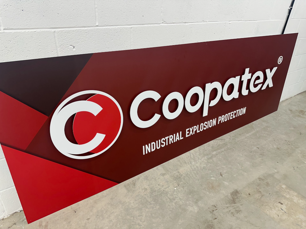 The Coopatex warehouse sign during installation