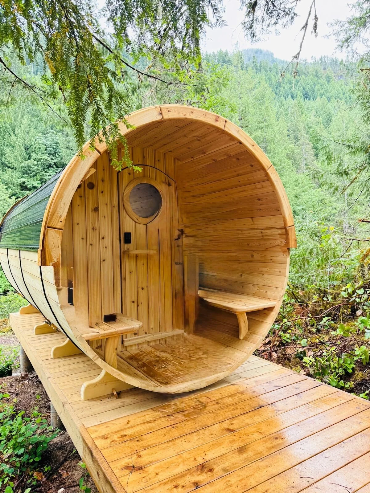 Cedar entrance and covered porch of a glamping barrel on Sproat Lake