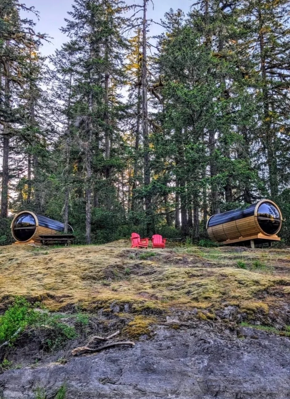 Two cedar glamping barrels in the forest at Sunset Island Resort