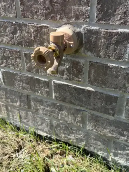 New Woodford frost-free outdoor spigot installed through a brick wall by Jaden in Carmel