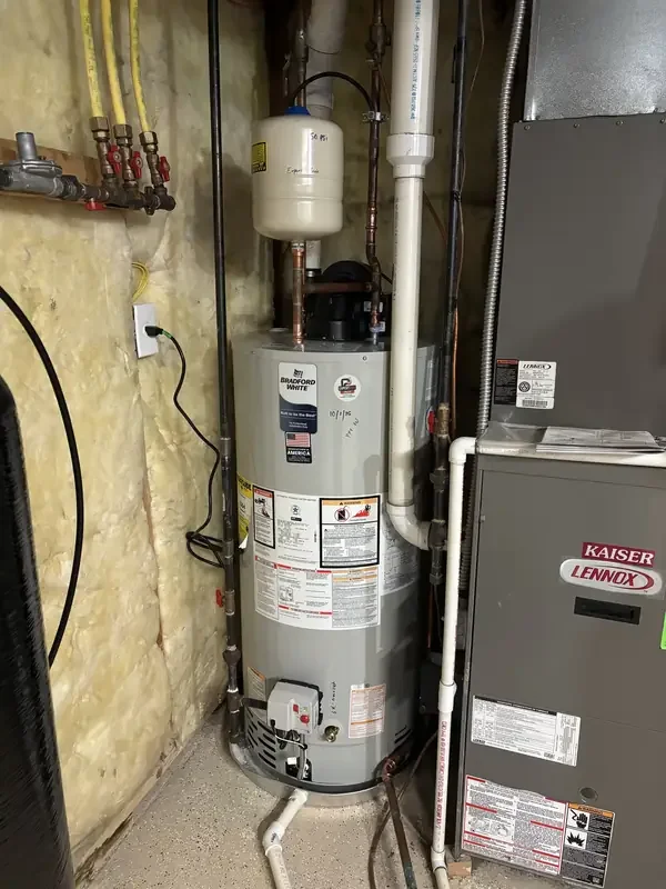 Bradford White 50-gallon power vent gas water heater with PVC exhaust vent and expansion tank installed by Jaden in Westfield 46074, dated 10/1/26