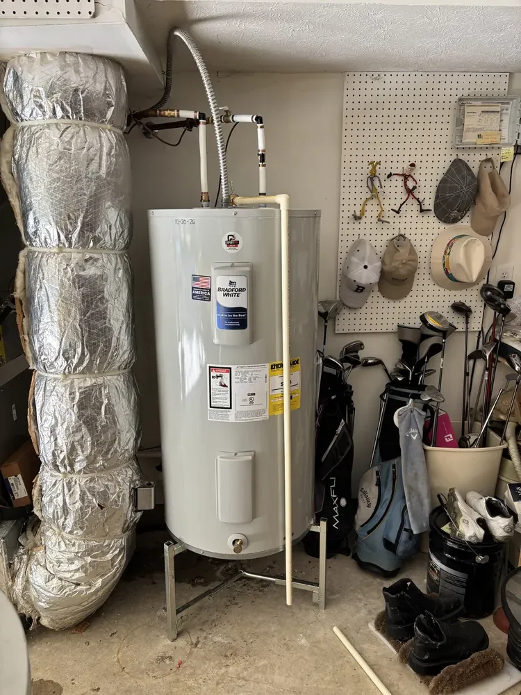 Bradford White electric water heater in a Fishers garage with new flexible water connectors, electrical whip and relief line