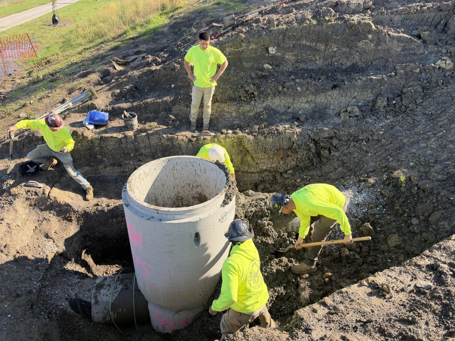 Cliff Contracting crew installing a concrete manhole at a job site